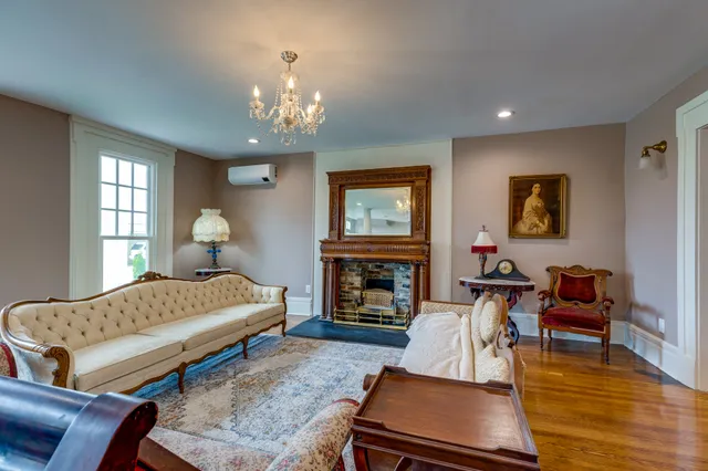 a living room with furniture a fireplace and a flat screen tv