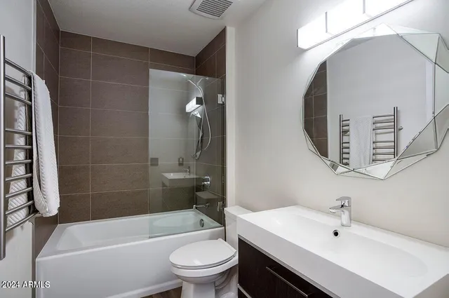 a bathroom with a sink a toilet and bathtub