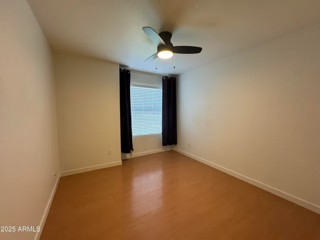 an empty room with closet and windows