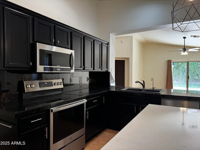 a kitchen with a sink stove and microwave