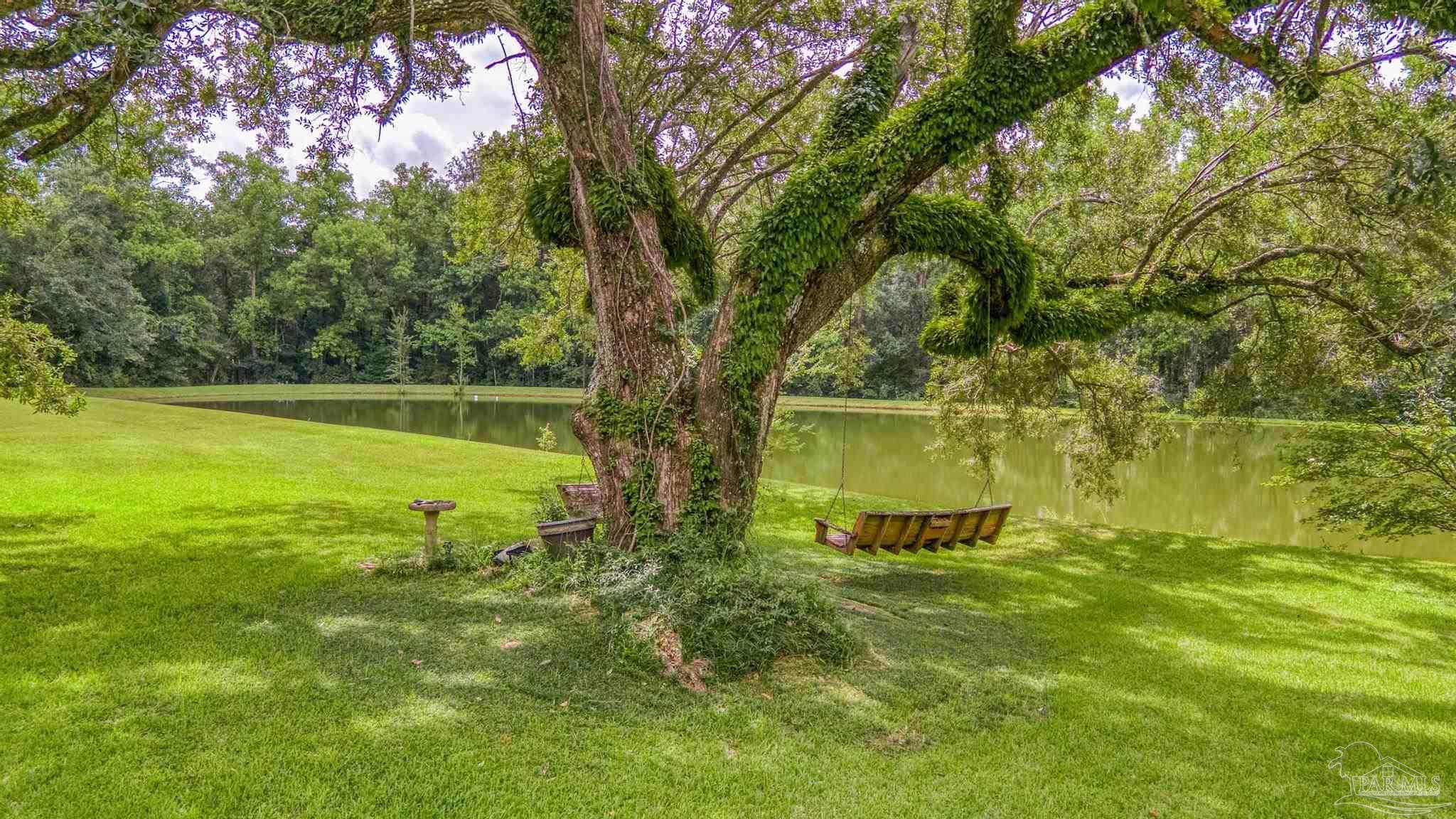 2345 Pompano Street Cantonment, FL 32533 - Photo 41 of 48 a view of a garden with a lake