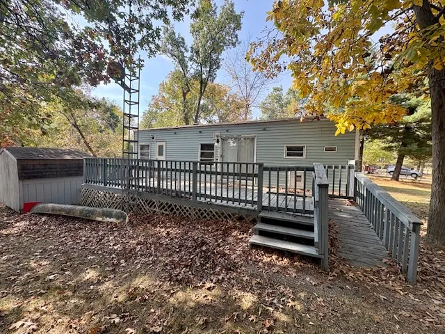 a view of a house with backyard and wooden fence