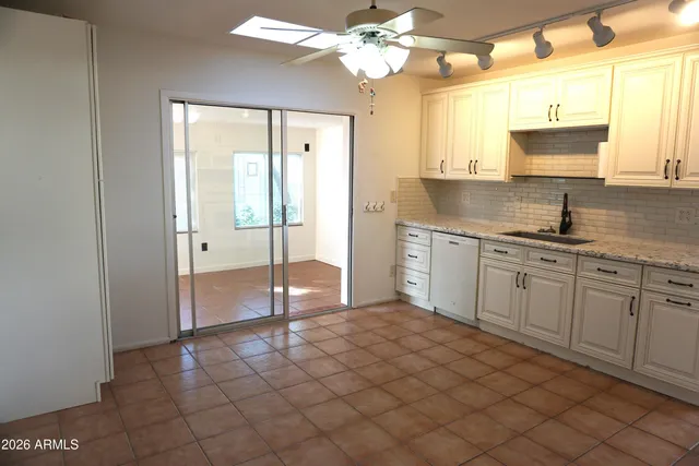 a spacious bathroom with a granite countertop sink a mirror and a shower