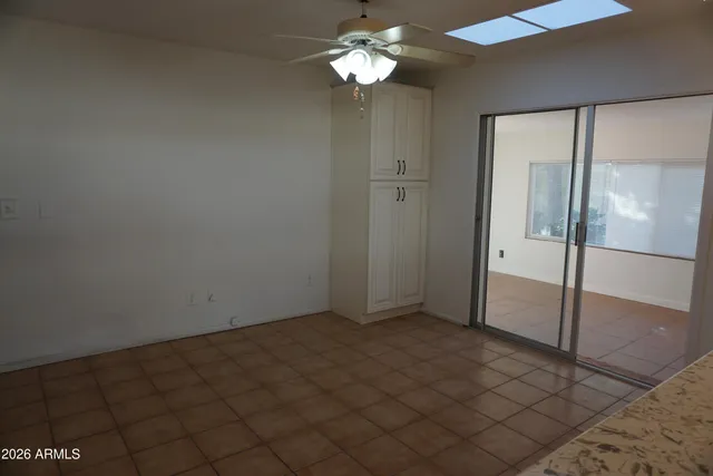 a view of a chandelier fan and fire place