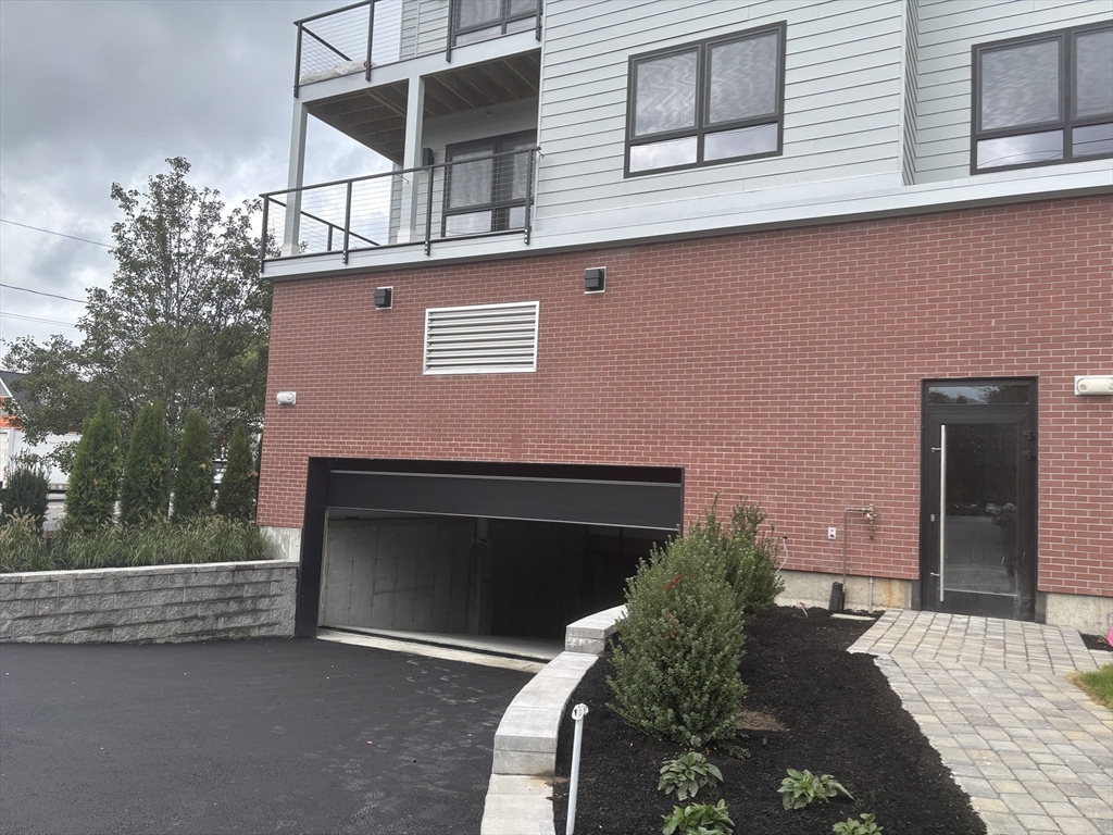 1391 Main Street, Unit 301 Walpole, MA 02081 - Photo 19 of 22 a front view of a house with entryway
