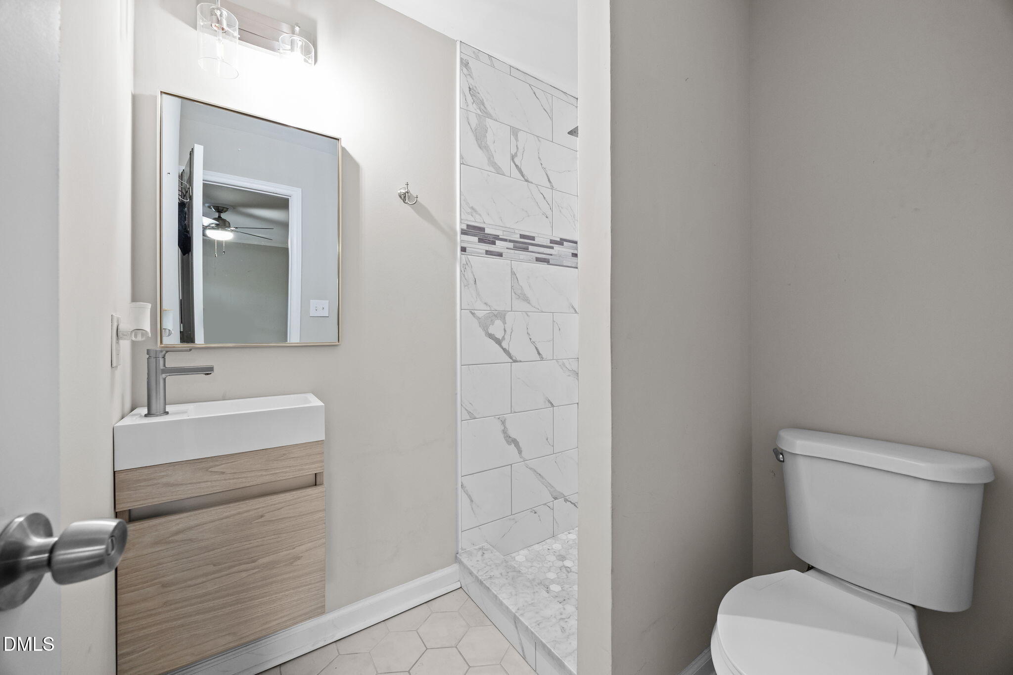 2950 Glenridge Drive Raleigh, NC 27604 - Photo 22 of 53 a bathroom with a sink a toilet and shower
