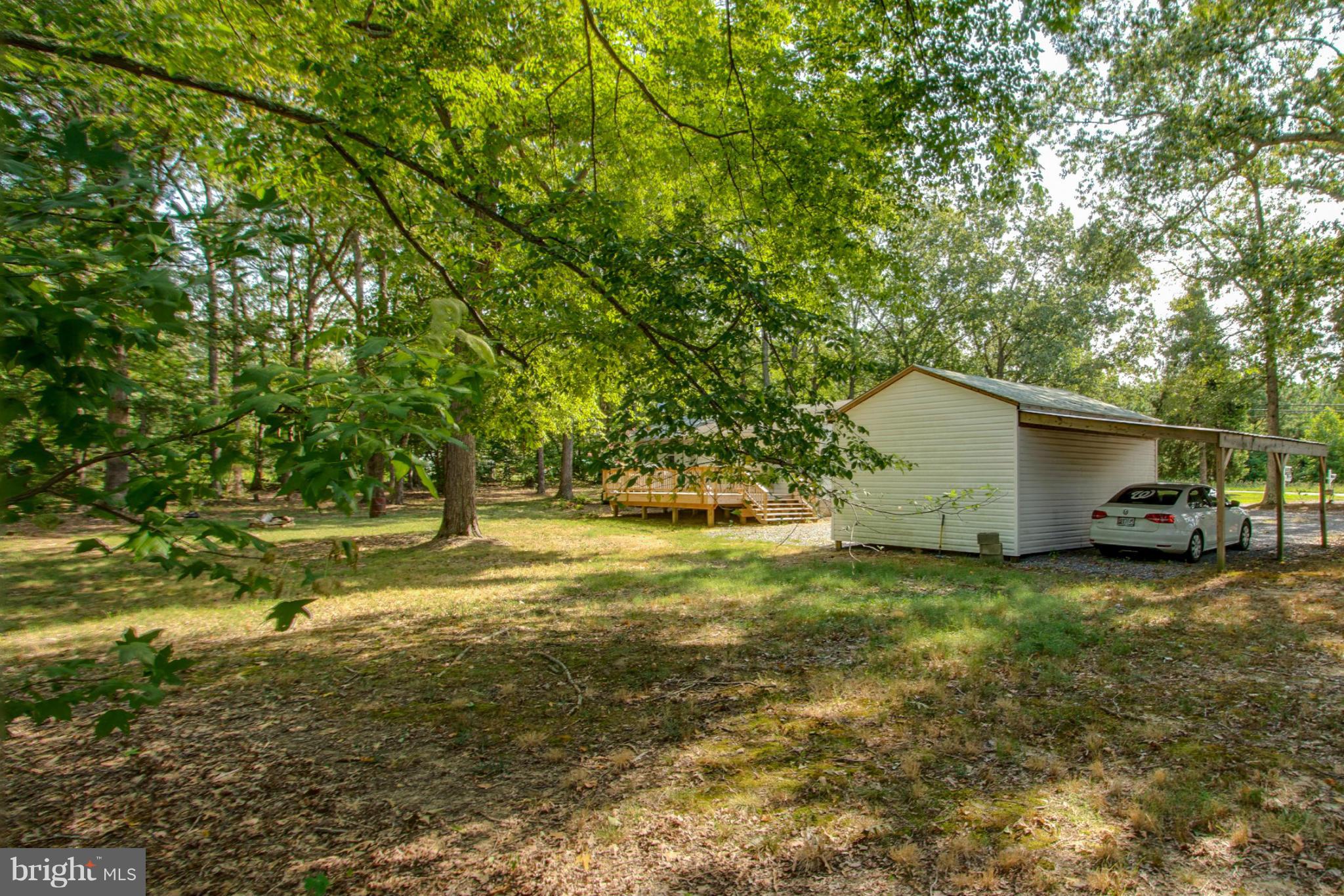 22501 Newtowne Neck Road Leonardtown, MD 20650 - Photo 26 of 27 Flat Backyard w/ View of Carport/Pole Barn