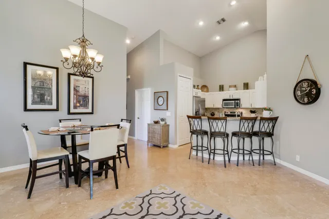 a view of a dining room with furniture and chandelier