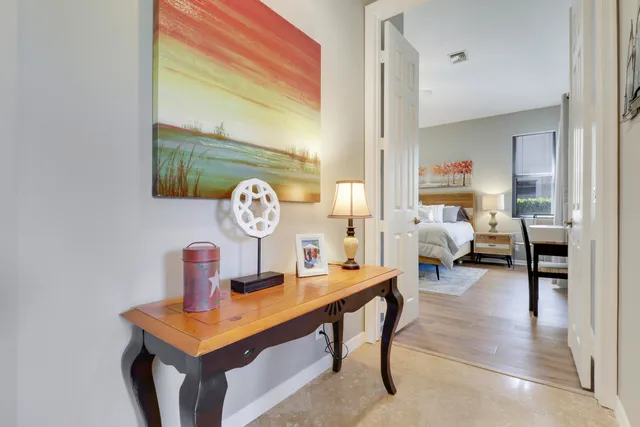 a living room with furniture a rug and a window