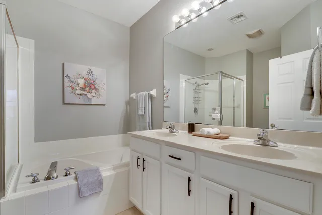 a bathroom with a double vanity sink mirror and double