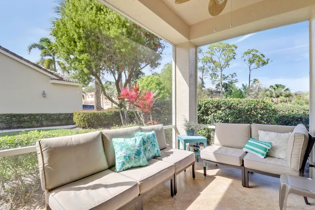 a view of a patio with couches table and chairs and potted plants