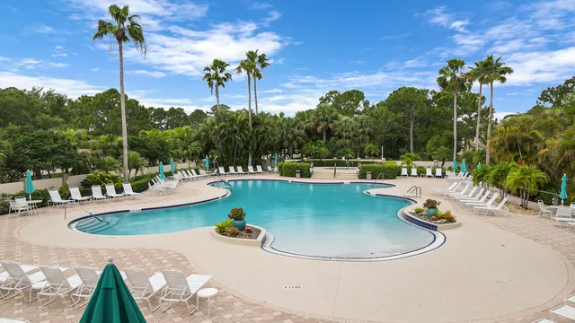 a view of a swimming pool with a table and chairs