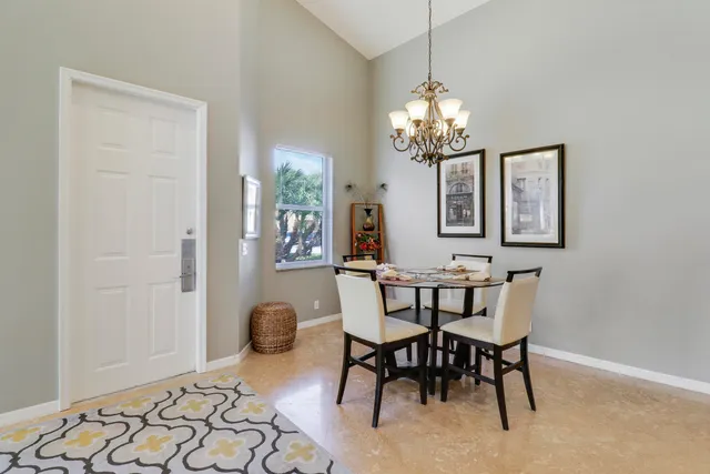 a view of a dining room with furniture and chandelier
