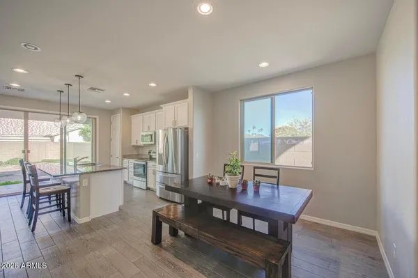 a dining room with furniture and wooden floor