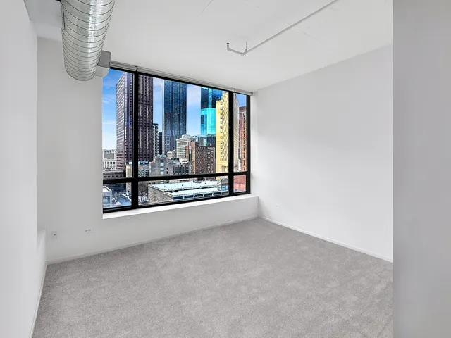 a view of a living room with a floor to ceiling window and floor