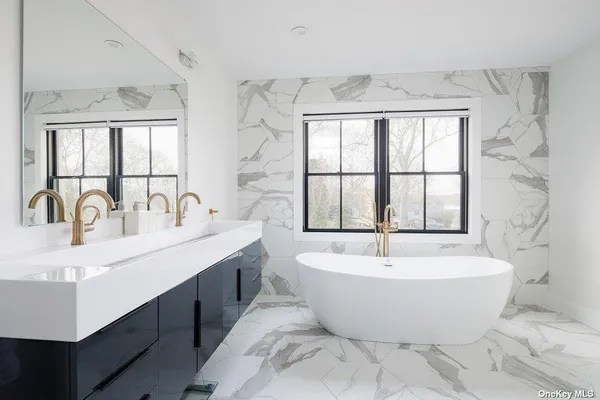 a view of a bathroom with a large tub and windows