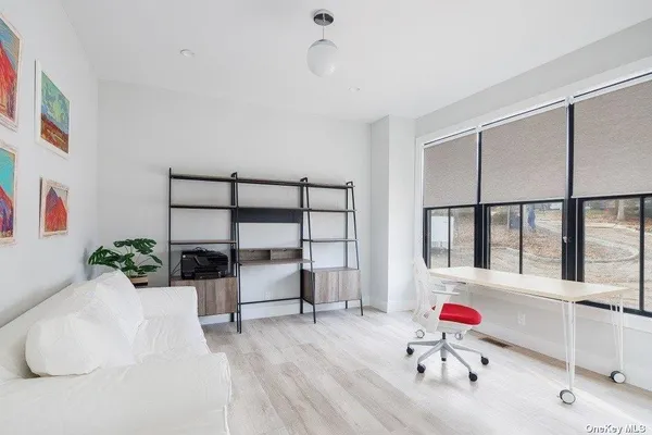 a bedroom with furniture and a window