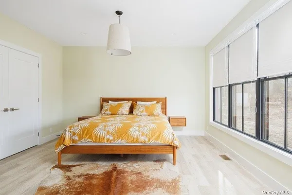 a bedroom with bed and window