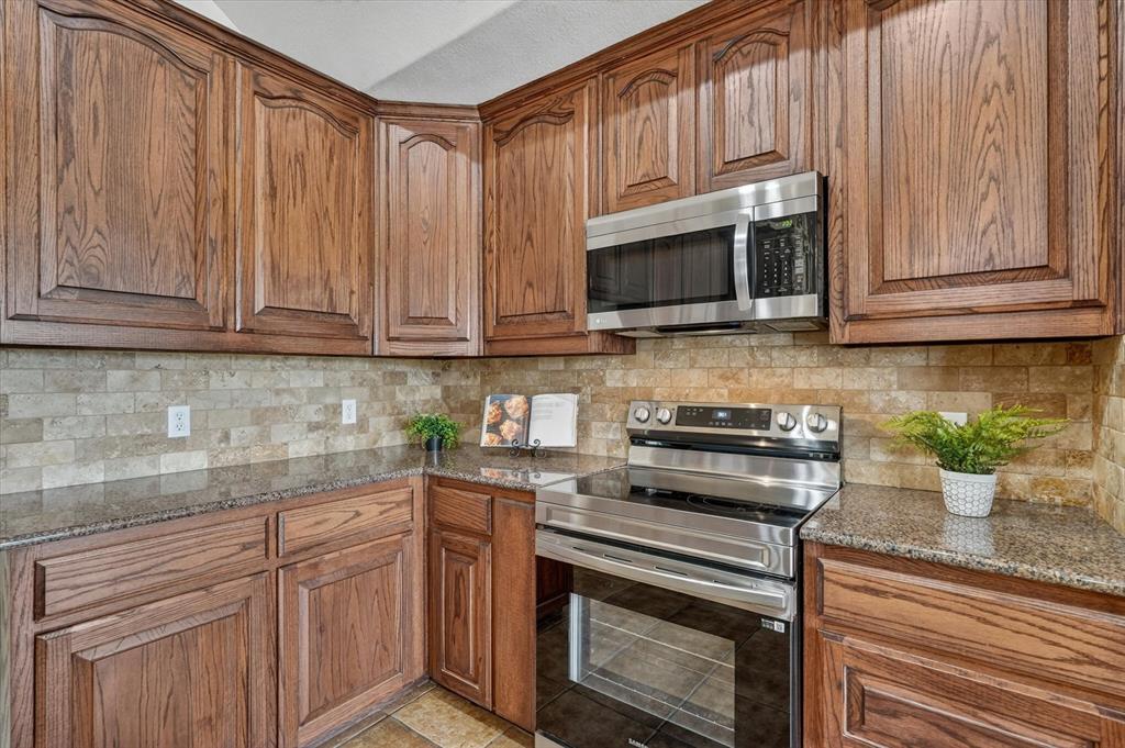 2828 Bennett Road Howe, TX 75459 - Photo 14 of 39 a kitchen with granite countertop cabinets stainless steel appliances and a counter space