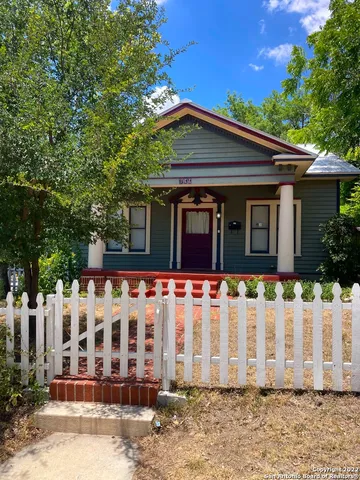 a view of a house with wooden fence