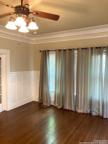 a view of a room with wooden floor