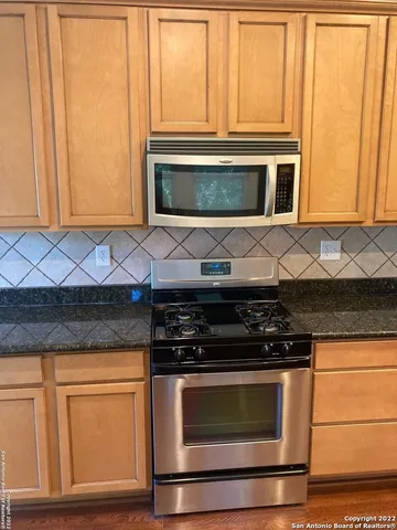 a stove top oven sitting inside of a kitchen