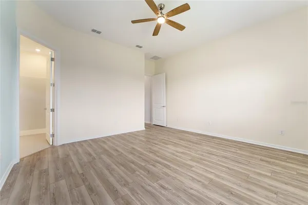 a view of walk in closet with empty racks