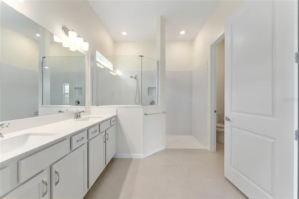 a bathroom with a double vanity sink and a mirror
