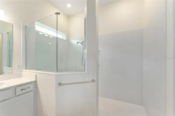 a bathroom with a shower and a mirror