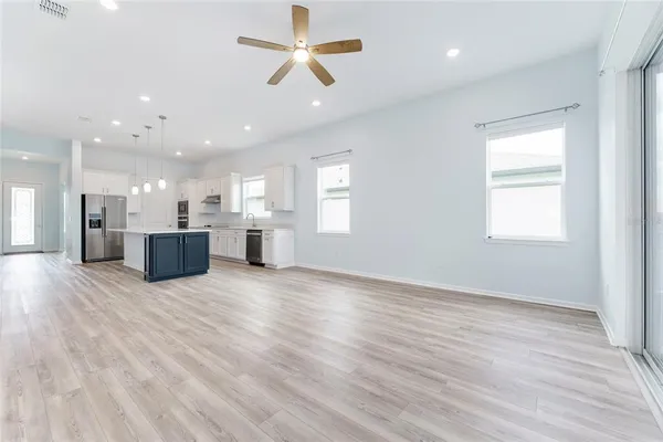a view of a kitchen with a sink and wooden floor