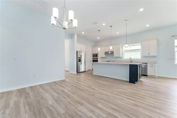a view of a kitchen with a dishwasher cabinets and wooden floor
