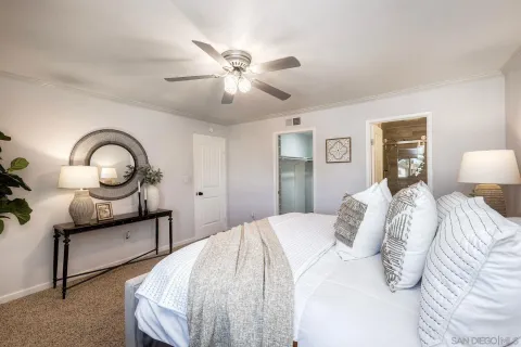 a bedroom with a bed and a chandelier