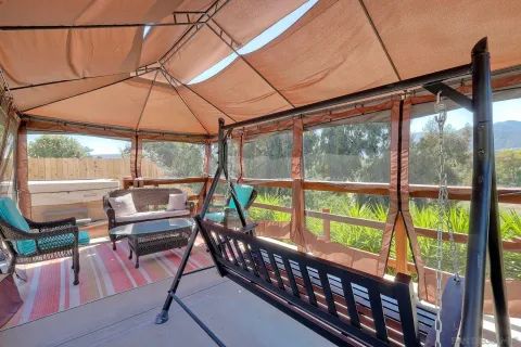 a view of a chairs and table in the patio