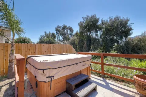 a view of a patio with table and chairs with wooden floor and fence