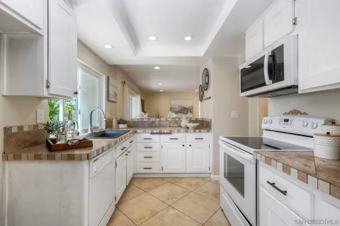 a kitchen with stainless steel appliances a stove a sink and a microwave