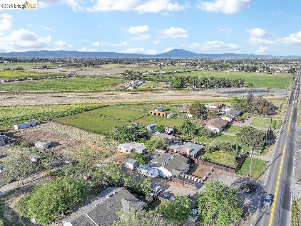 2191 East Cypress Road Oakley, CA 94561 - Photo 48 of 48 Aerial view of sparsely populated area with a mountain backdrop and nearby suburban area