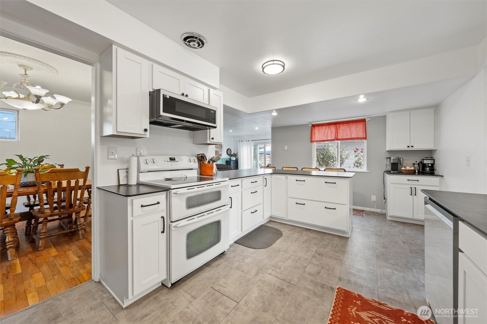 1162 D Street Southwest Ephrata, WA 98823 - Photo 11 of 37 a kitchen with stainless steel appliances granite countertop a stove top oven a sink dishwasher and white cabinets with wooden floor