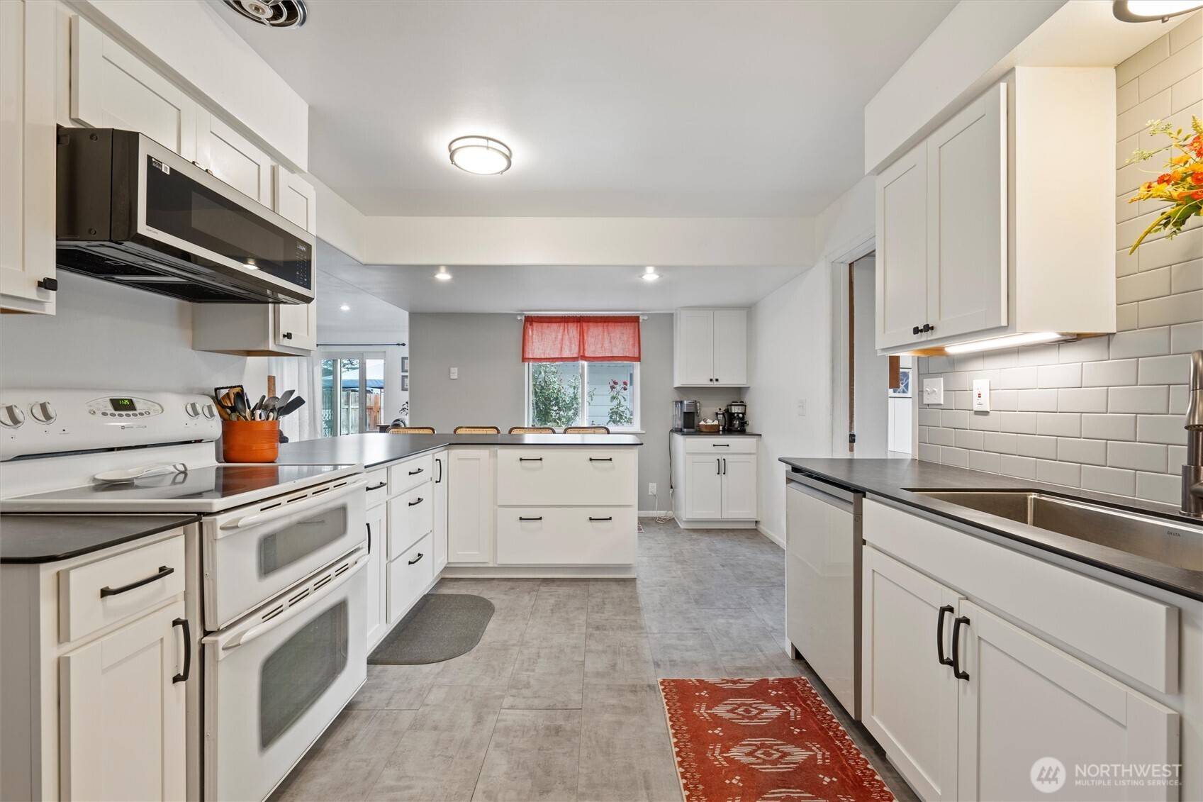 1162 D Street Southwest Ephrata, WA 98823 - Photo 12 of 37 a kitchen with white cabinets appliances and a window