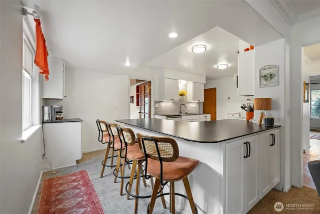 a kitchen with stainless steel appliances kitchen island granite countertop a sink and cabinets