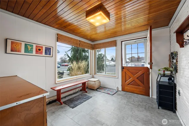a backyard of a house with barbeque oven table and chairs