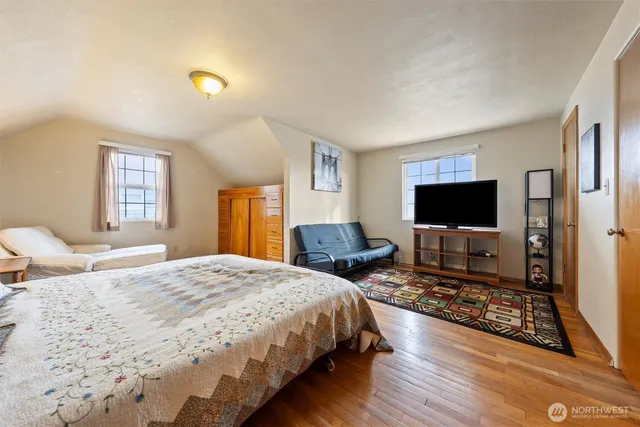 a bedroom with a bed and a flat screen tv