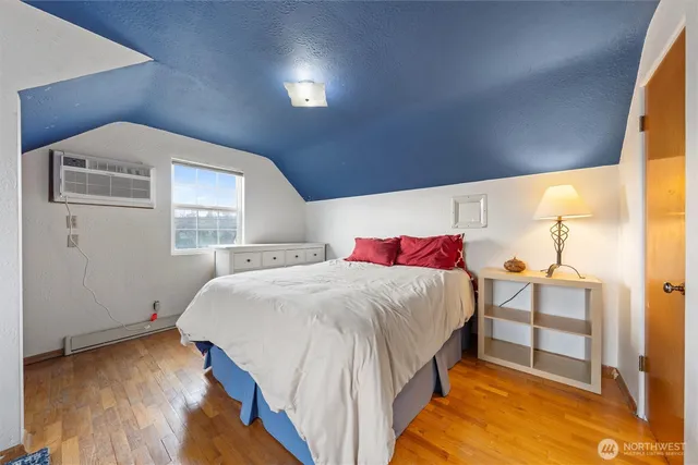 a spacious bedroom with a bed and a window