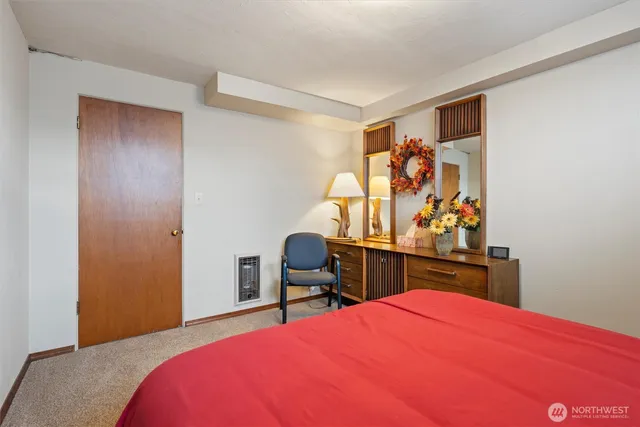 a bedroom with a bed and a desk