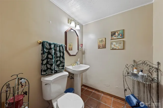 a bathroom with a toilet a sink and a mirror