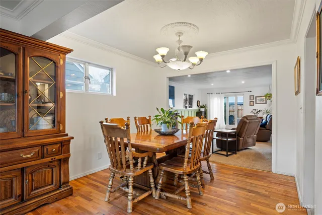 a view of a dining room with furniture wooden floor and chandelier