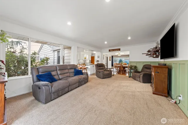 a living room with furniture a flat screen tv and a fireplace