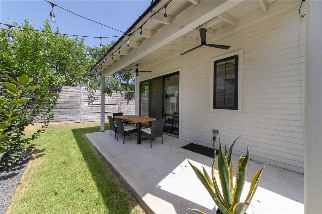 2002 East 9th Street, Unit 2 Austin, TX 78702 - Photo 19 of 32 A private outdoor living space offers covered dining and lush green surroundings.