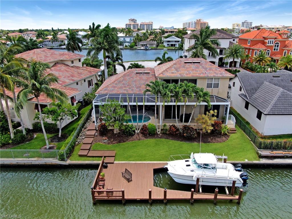 a aerial view of a house with swimming pool garden and lake view