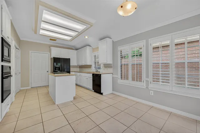 a kitchen with stainless steel appliances kitchen island granite countertop a sink and a stove top oven