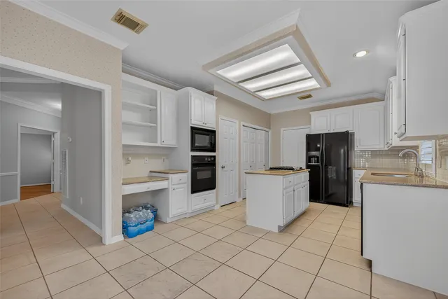 a kitchen with a refrigerator and cabinets